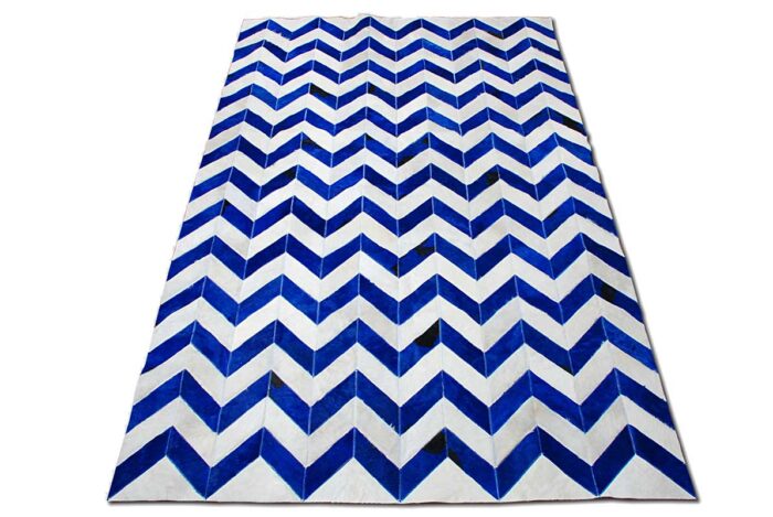 Blue and white cowhide patchwork rug in a chevron design