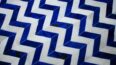 Top view of a chevron blue and white cowhide patchwork rug