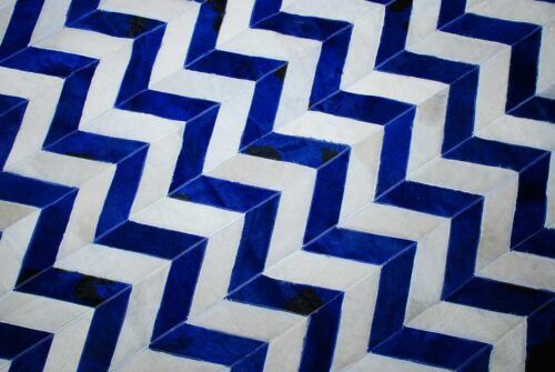 Top view of a chevron blue and white cowhide patchwork rug