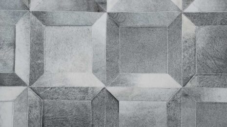 Top view of a gray Cube patchwork cowhide rug