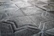 Hair detail of a dark gray patchwork cowhide rug in our Moorish star design