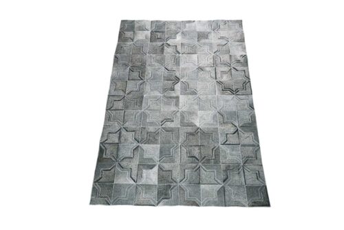 Dark gray patchwork cowhide rug in a moorish star design