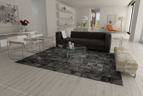 Dark gray patchwork cowhide rug in a moorish star design in a minimal living room
