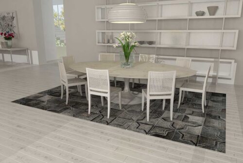 Dark gray patchwork cowhide rug in a moorish star design in a white dining room