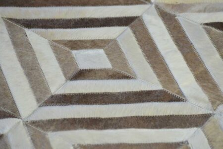 Detalle de pelo en piel de alfombra de cuero blanco y beige con diseño de rombos Detalle de pelo en piel de alfombra de cuero blanco y beige con diseño de rombos