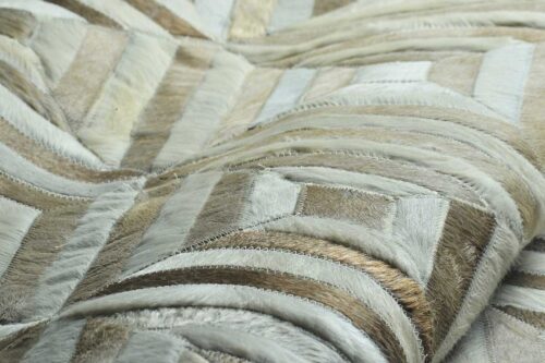 Texture detail of white and beige leather area rug in diamond design