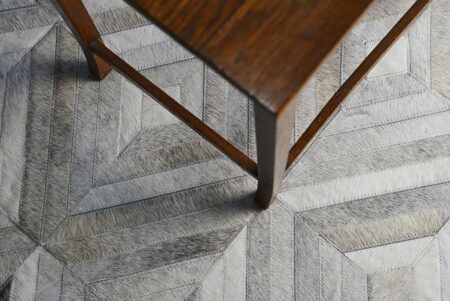 Gray cowhide patchwork rug, wooden table Diamond gray cowhide patchwork rug