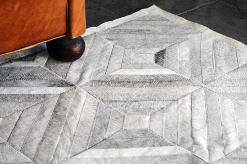 Diamond gray cowhide patchwork rug furniture detail