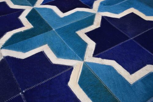 Close up of our Moorish Star Blue and White cowhide patchwork rug