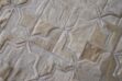 Top view of detail of white patchwork cowhide rug in moorish star design