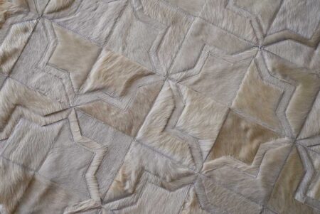 Moorish Star cowhide rug in white natural hide Top view of detail of white patchwork cowhide rug in moorish star design