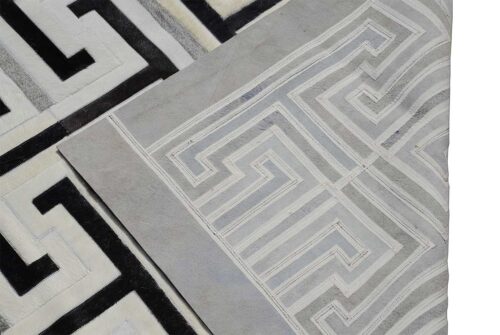 Close up of black, gray and white patchwork cowhide rug showing backing