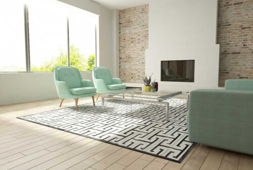 Black, gray and white patchwork cowhide rug design in sunny living room