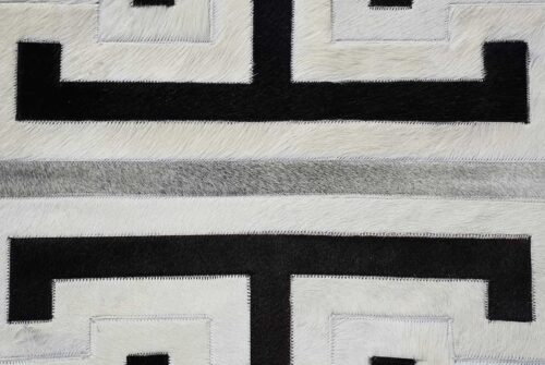 Detail of black, gray and white patchwork cowhide rug in geometric design