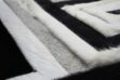 Hair on hide detail of Black, gray and white patchwork cowhide rug design