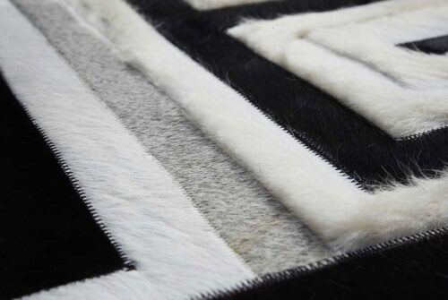 Hair on hide detail of Black, gray and white patchwork cowhide rug design