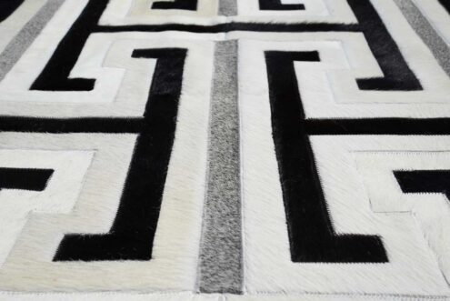 Close up of black, gray and white patchwork cowhide rug design Close up of black, gray and white patchwork cowhide rug design