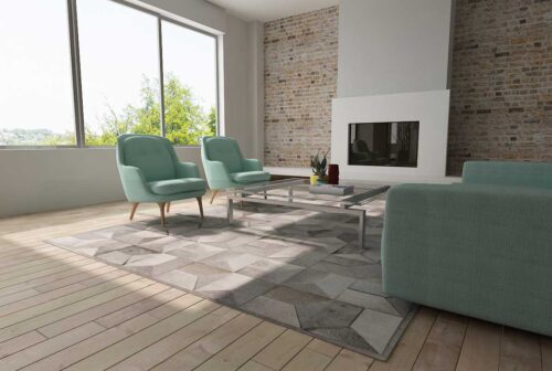 Taupe Gray Envelope Patchwork Cowhide Rug with teal sofas