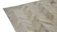 Detail of white herringbone patchwork cowhide rug, no border.