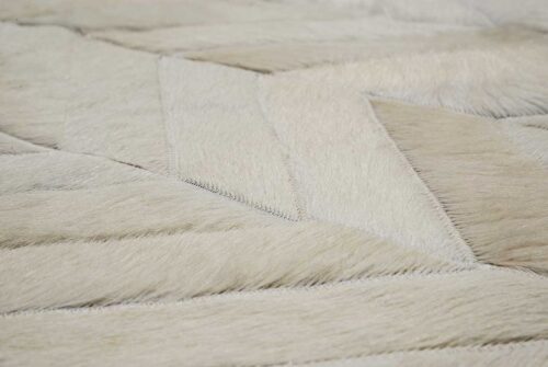 Detail of white herringbone patchwork cowhide rug