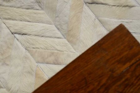 White chevron cow hide patchwork rug, dark wood White chevron cow hide patchwork rug, dark wood