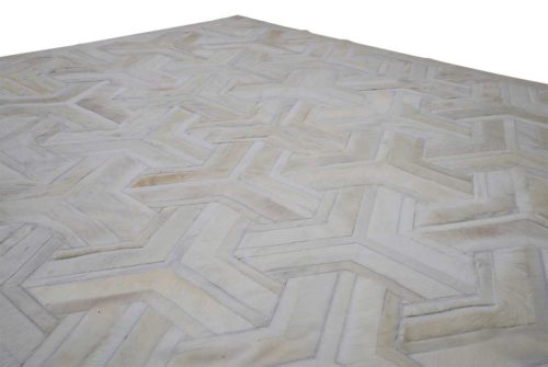 White patchwork cowhide rug corner