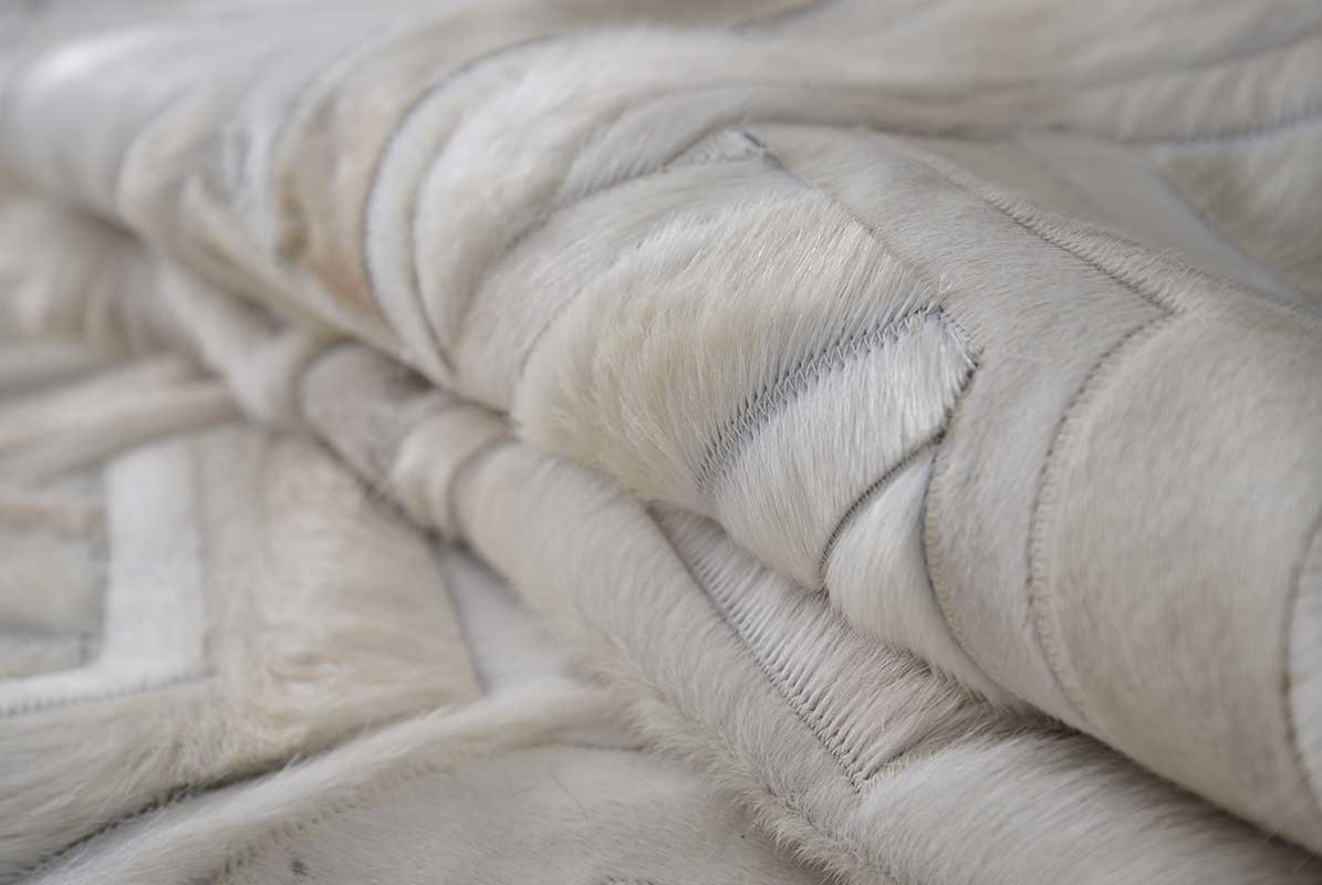 Detail of white cowhide patchwork rug in TOTO design