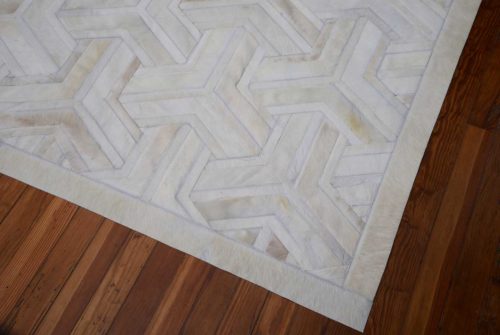 White patchwork cowhide rug 7 inches border
