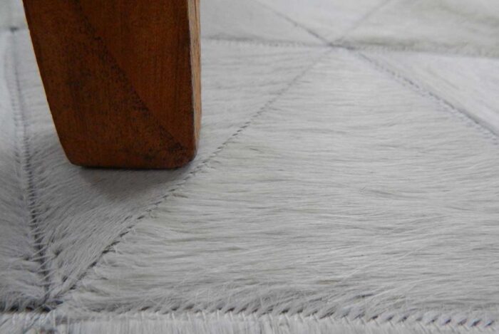 Detail of white cow hide patchwork rug in triangles design