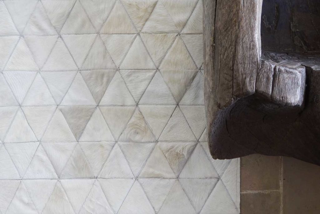 wood and white cowhide rug