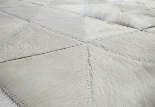 Detail of white cowhide patchwork rug in triangles design