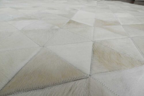 Detail of white cowhide patchwork rug in triangles design