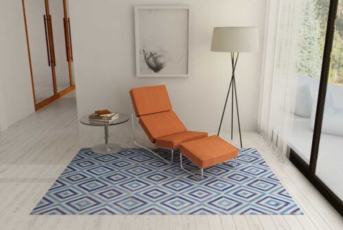 Blue and Gray Diamond Patchwork Cowhide Rug in reading nook with orange chaise