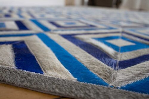 Floor view of a Blue and Gray Diamond Patchwork Cowhide Rug