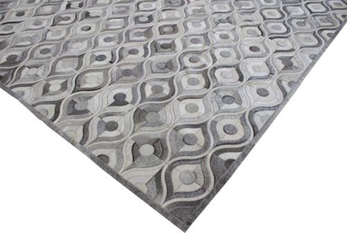 Gray and white cowhide patchwork rug border
