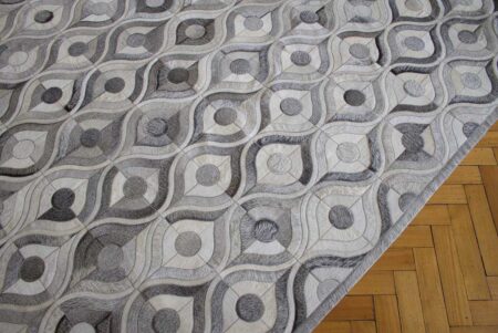 Gray and white cowhide patchwork rug with hair border Gray and white cowhide patchwork rug with hair border