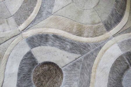 Detail of gray and white cow hide patchwork rug Detail of gray and white cow hide patchwork rug
