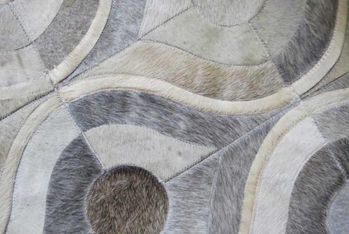 Detail of gray and white cow hide patchwork rug