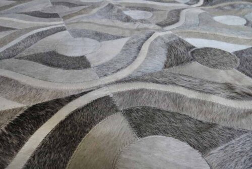 Detail of gray and white patchwork hide rug in retro design