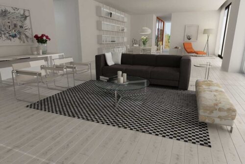 Checkerboard patchwork cowhide rug in a white living room with Wassily chairs