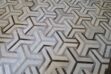 White and taupe cowhide patchwork rug in TOTO design