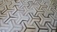White and taupe cowhide patchwork rug in TOTO design