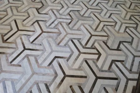 White and taupe cowhide patchwork rug in TOTO design White and taupe cowhide patchwork rug in TOTO design