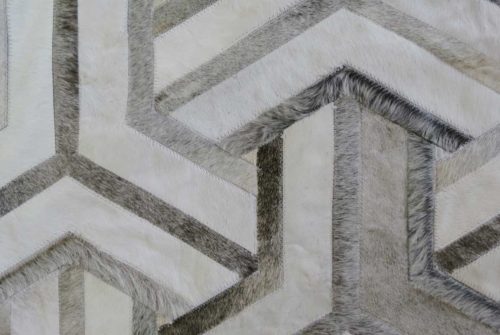 Detail of white and taupe cowhide patchwork rug