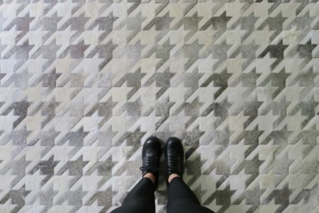 Top view of a White and gray Leather Area cowhide Rug Houndstooth Design Top view of a White and gray Leather Area cowhide Rug Houndstooth Design