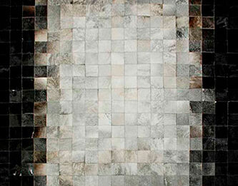 White, gray and black patchwork cowhide rug in squares
