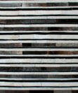 White, gray and black leather area rug in stripes