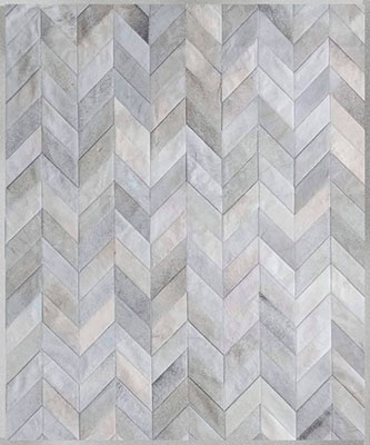 Gray cowhide patchwork rug in a chevron design