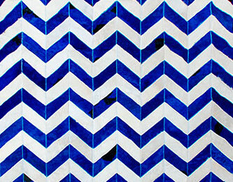 Blue and white cowhide patchwork rug in a chevron design