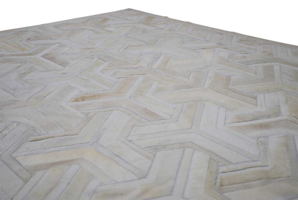 White TOTO cowhide patchwork rug corner